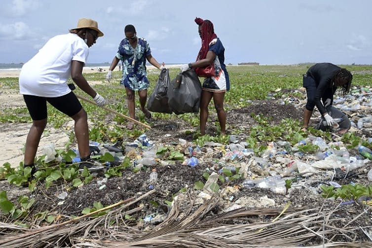 Volunteers gather at a beach, to clean up plastic litter at a Lagos beach.
PIUS UTOMI EKPEI/AFP via Getty Images