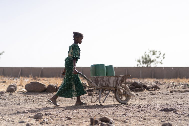 A young woman fetching water. Climate change literacy rates in Nigeria range from 71% in Kwara to 5% in Kano.
Shutterstock